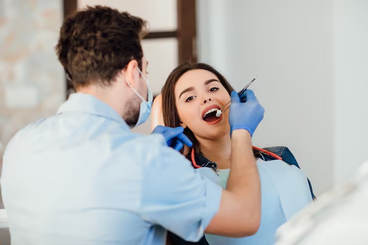 sherwood dentist A hygienist performs a gentle dental hygiene cleaning for a patient.